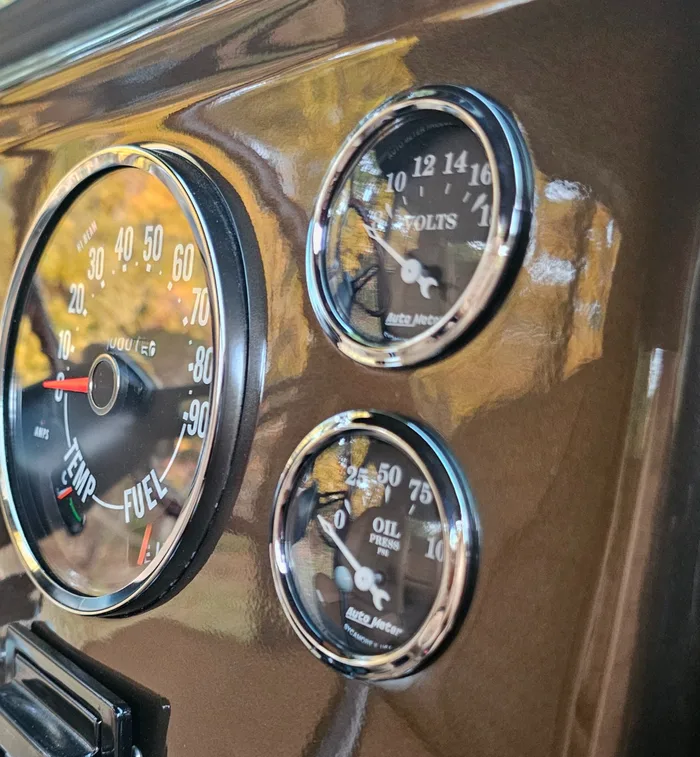 Chrome-bezel gauge cluster in a freshly painted classic dashboard