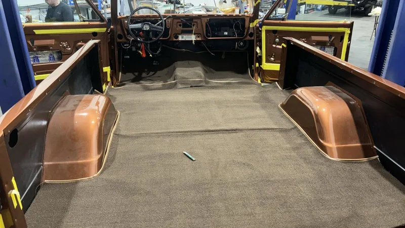 Classic pickup bed with copper-painted wheel wells during restoration