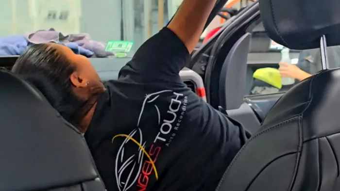 Angels Touch technician working inside a car interior