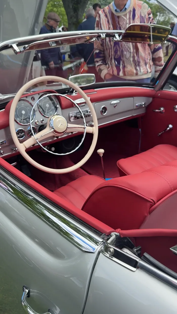 Vintage Mercedes-Benz convertible interior with red leather seats and cream steering wheel