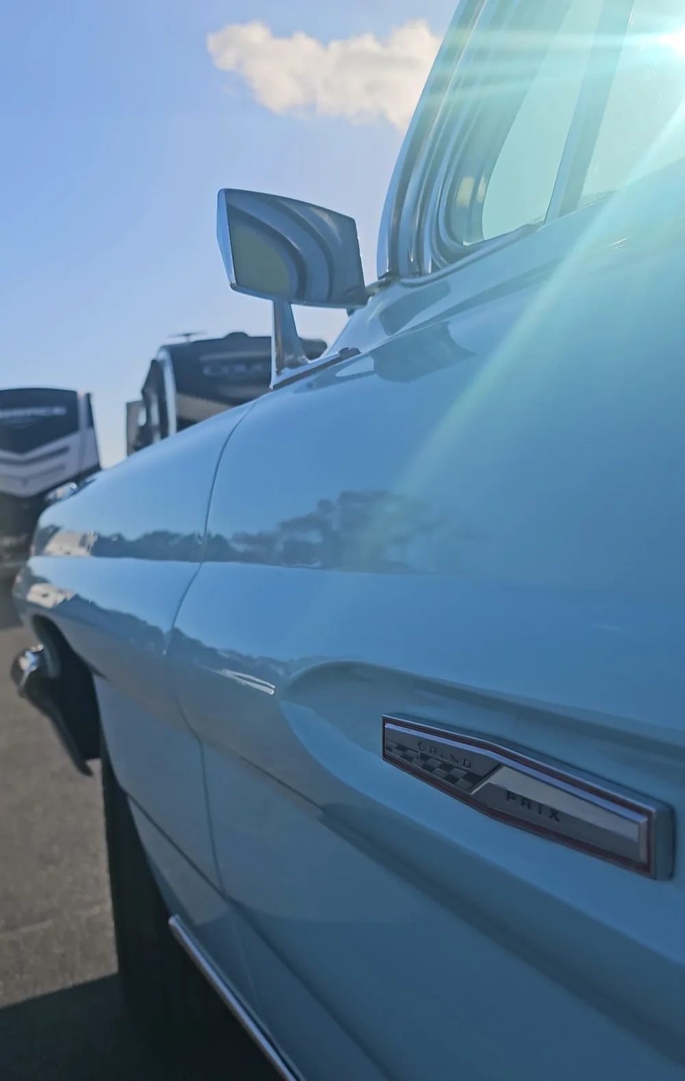 Sunlight glinting off the freshly detailed blue paint of a classic pickup