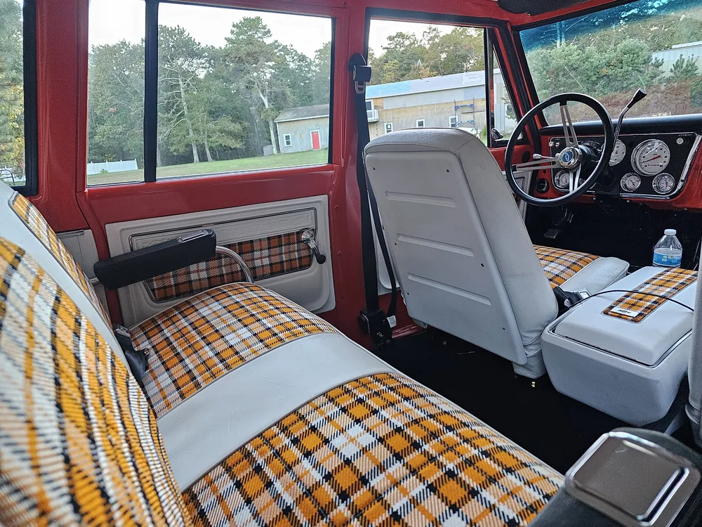 Restored truck interior with custom plaid bench seat upholstery